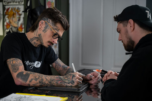 Tattoo artist preparing to start a tattoo Tattoo artist preparing to start a tattoo