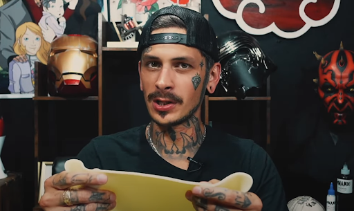 artist holding tattoo practice skin artist holding tattoo practice skin