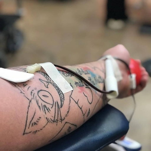donating blood Person with a large forearm tattoo donating blood