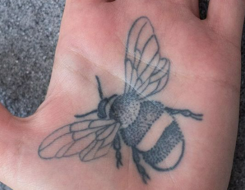 dot shading bee tattoo artist applies dot shading to bee tattoo