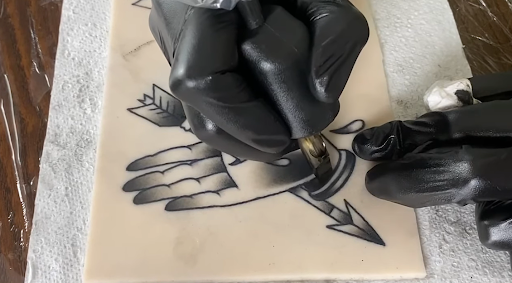 hand and arrow tattoo