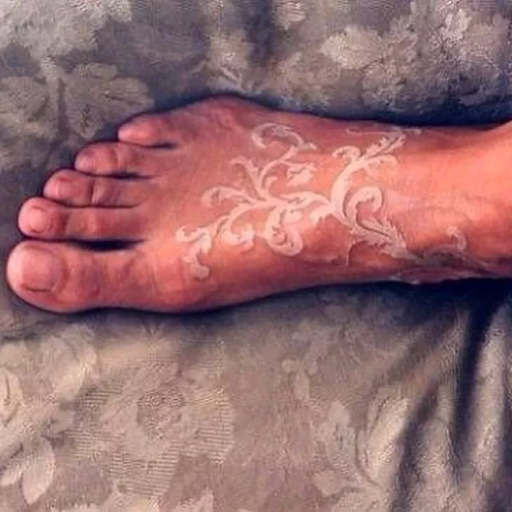 Lacy white ink tattoo