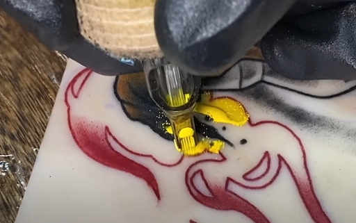 successful tattoo artist using practice skin