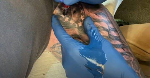 tattoo artist tattooing