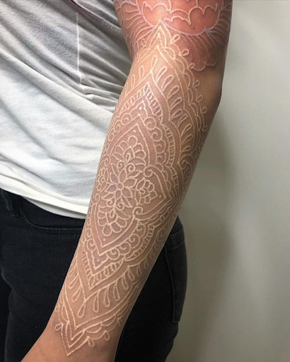 white ink tattoo with raised skin